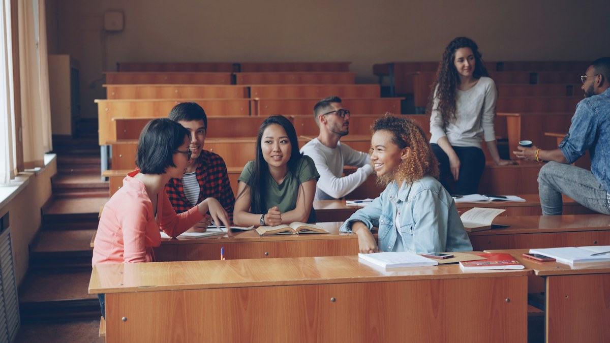 Students talking together in a university lecture room